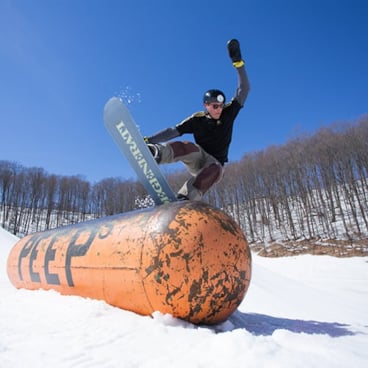 Snowboarder Grinding on PEEPs Pill Feature