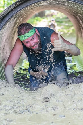 Guy crawling through mud