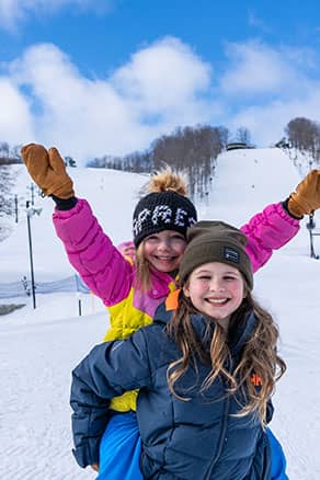 girls rejoicing on the slopes