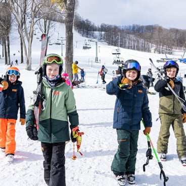 Kids walking with skis at Boyne Mountain