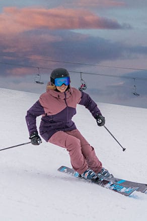 female skier ripping down the slopes
