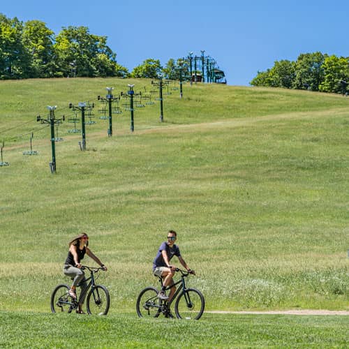couple riding bike on scenic path