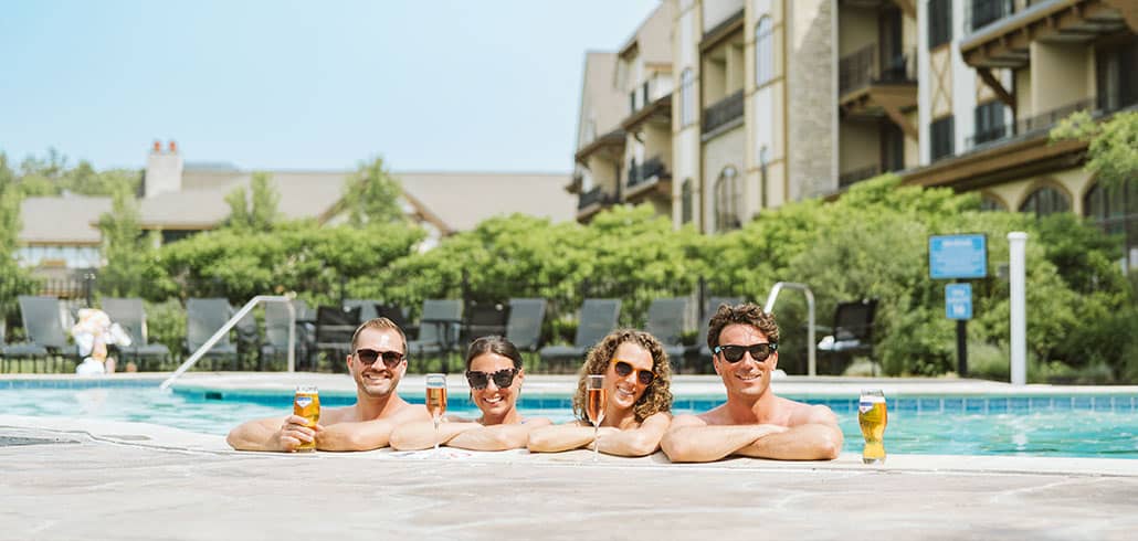 Couple drinking champagne by Pool at Boyne Mountain Resort