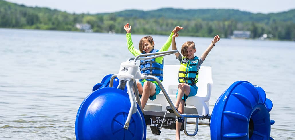 Young boys on Aqua Cycle at Deer Lake at Boyne Mountain