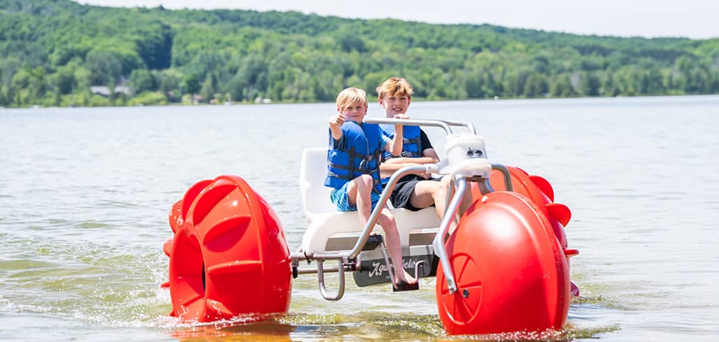 Young boys on Aqua Cycle at Deer Lake at Boyne Mountain