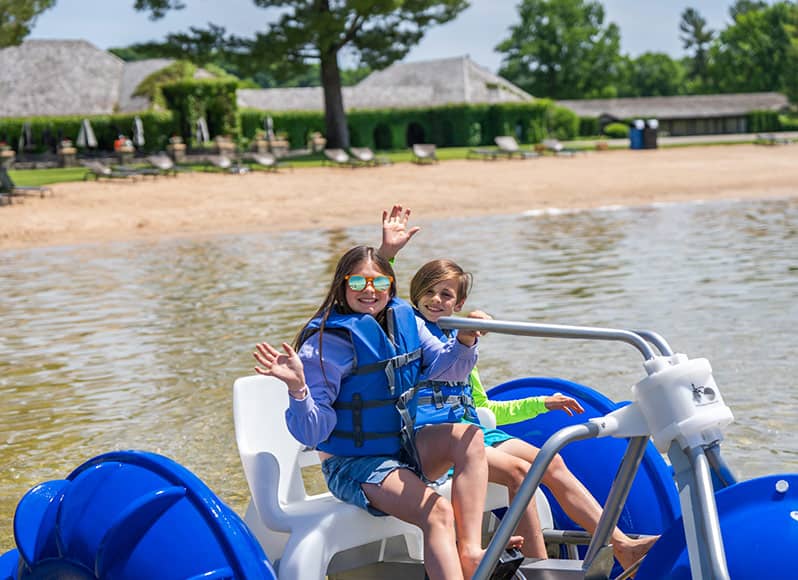 Sibling children on Aqua Cycle at Deer Lake at Boyne Mountain