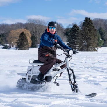 Moonbike riding through deep snow 