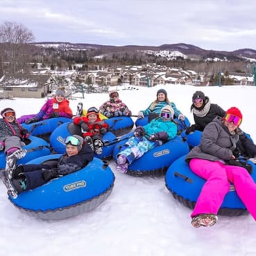 People having fun snow tubing