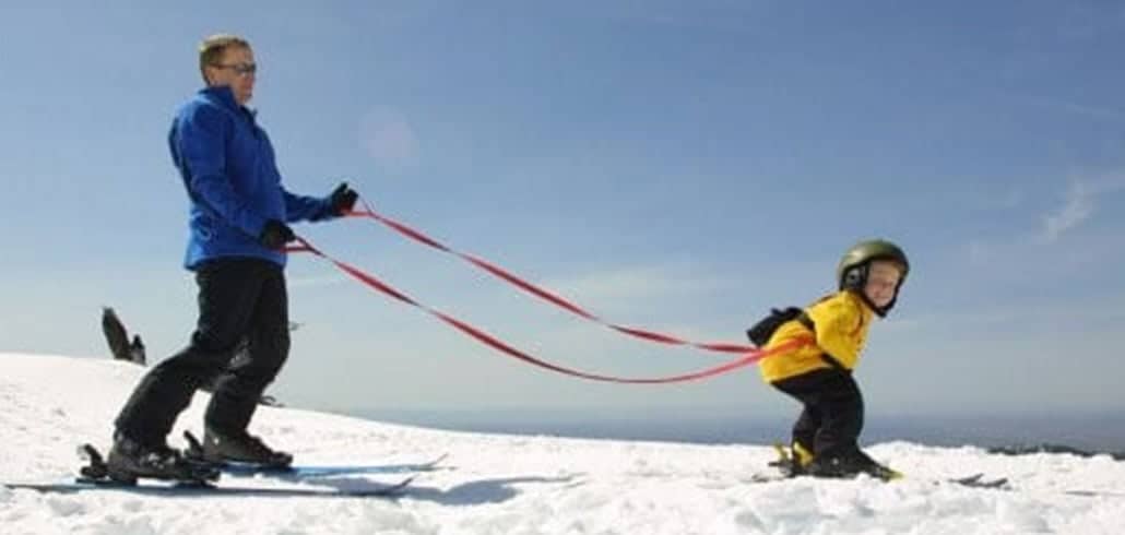 leashed child skiing