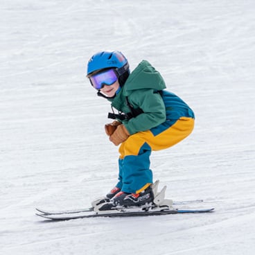 Toddler skiing and smiling